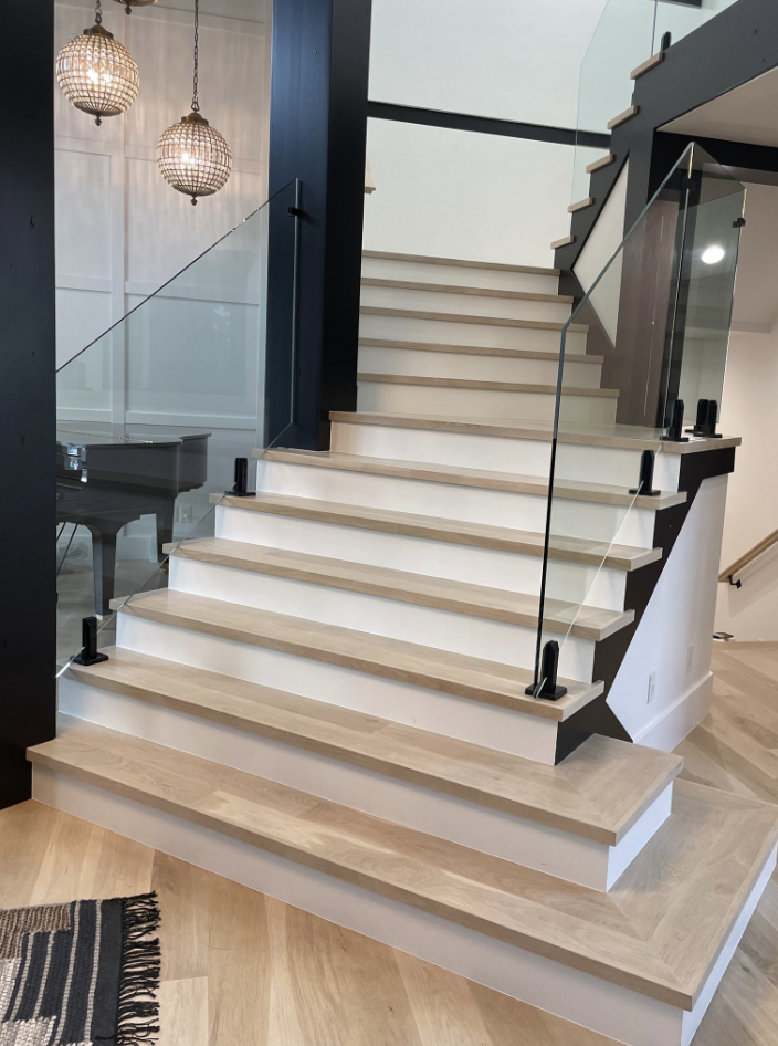 Custom glass railing staircase installation — Pine River Construction, Utah